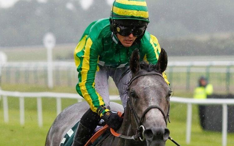 Jockey racing at Bath Racecourse.