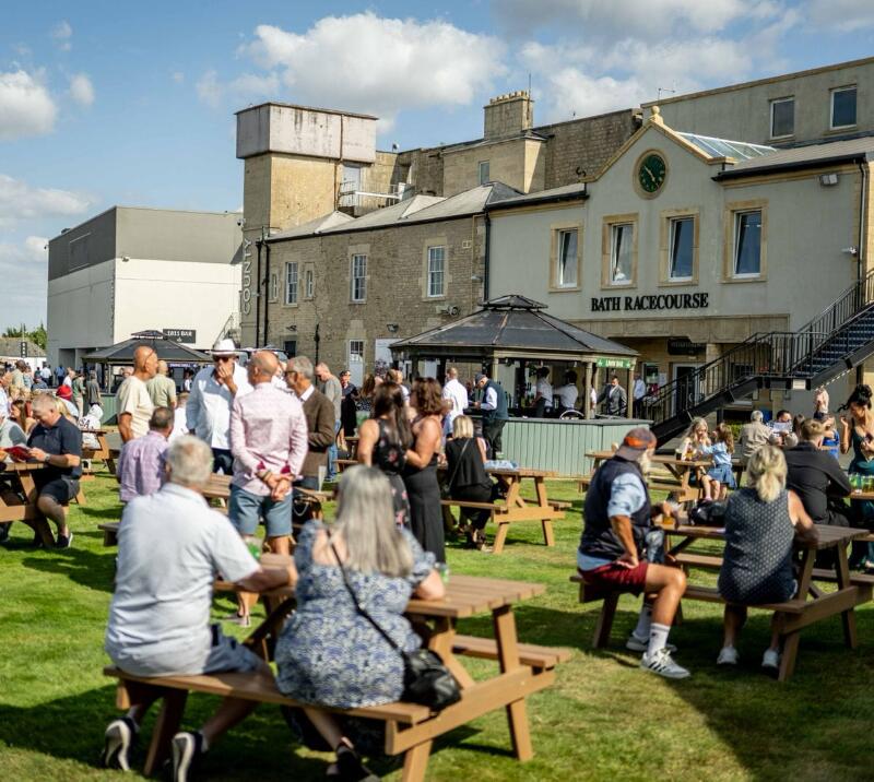 Crowds relaxing at Bath Racecourse during a race day