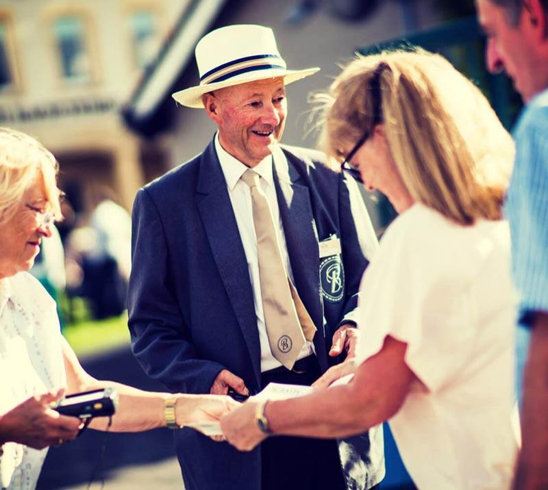 Gate staff checking tickets at Bath Racecourse.