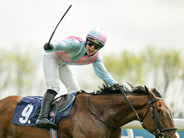 Jockey cheering as they cross the finish line
