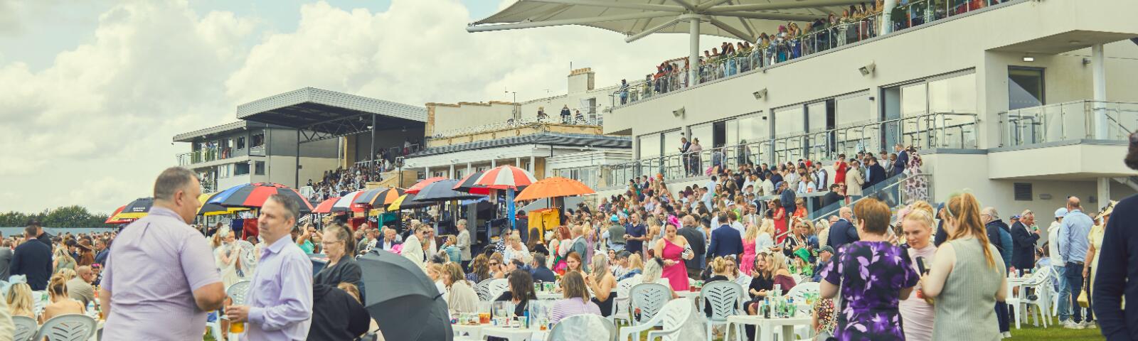The crowds in front of the grandstands of Bath Racecourse