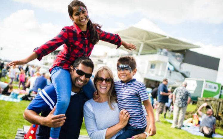 Family posing for a photo during a family fun day at Bath Racecourse.