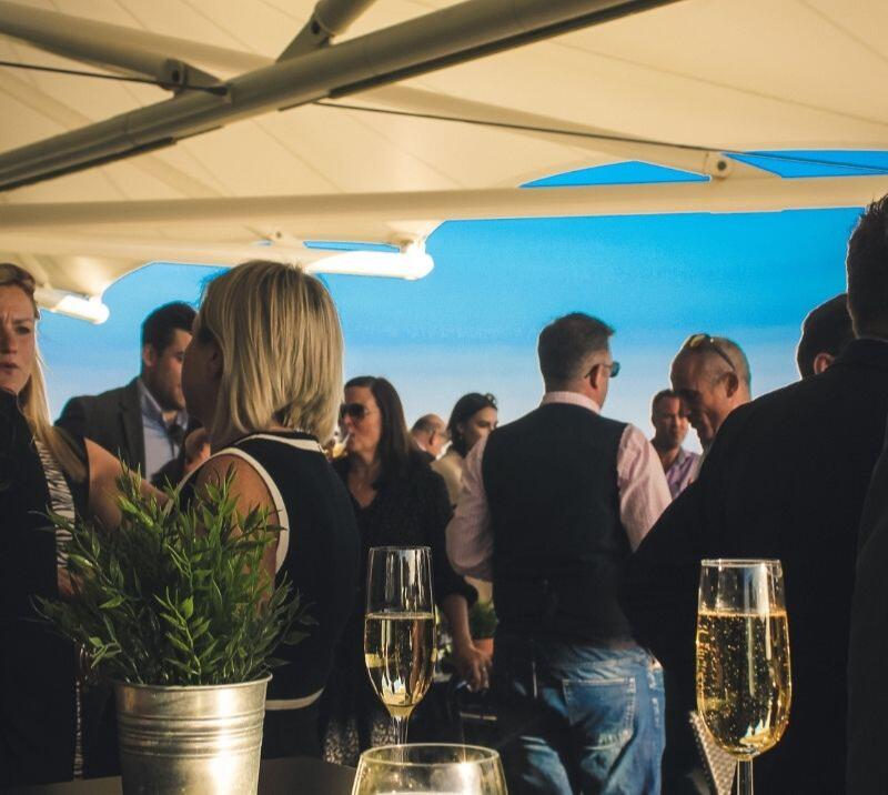 Crowds at Roof Garden Terrace at Bath Racecourse.