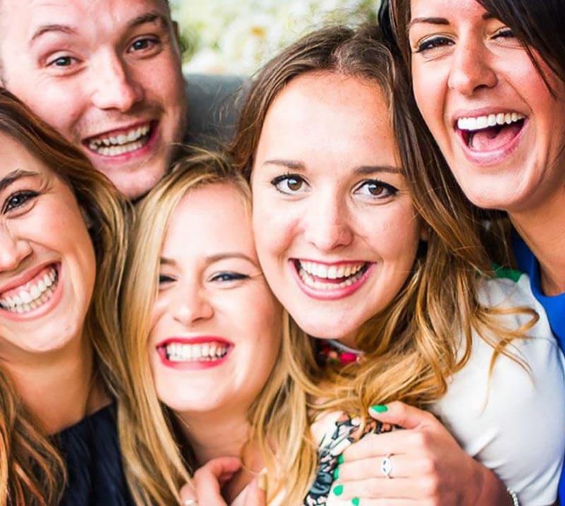 Close up on a group of happy racegoers.