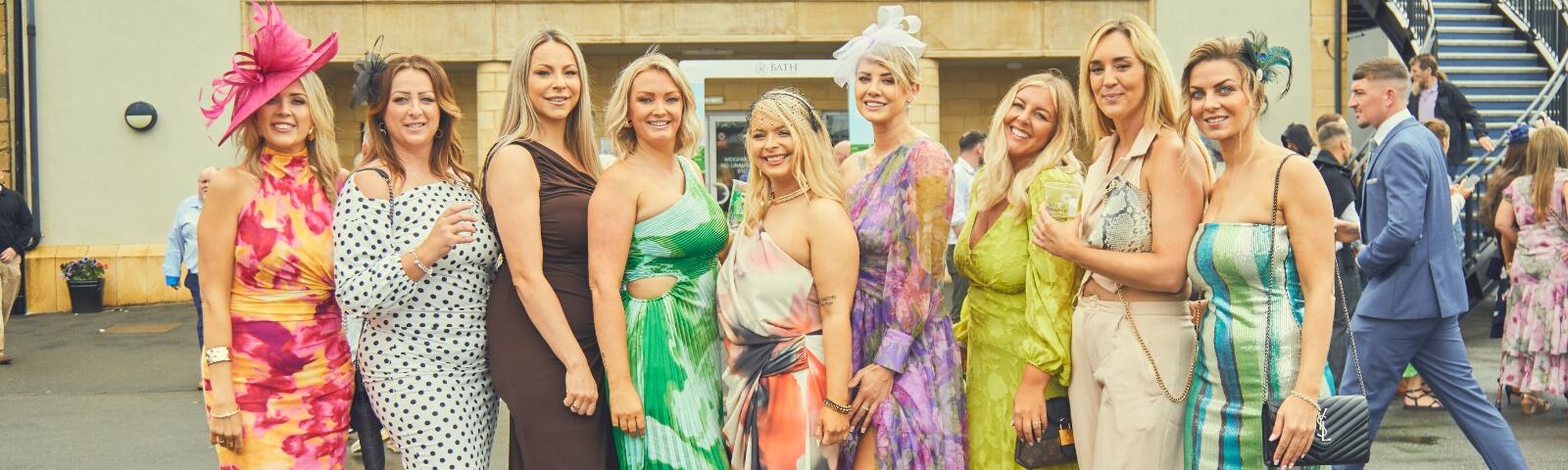 A group of ladies dressed up in dresses for Ladies Day at Bath Racecourse