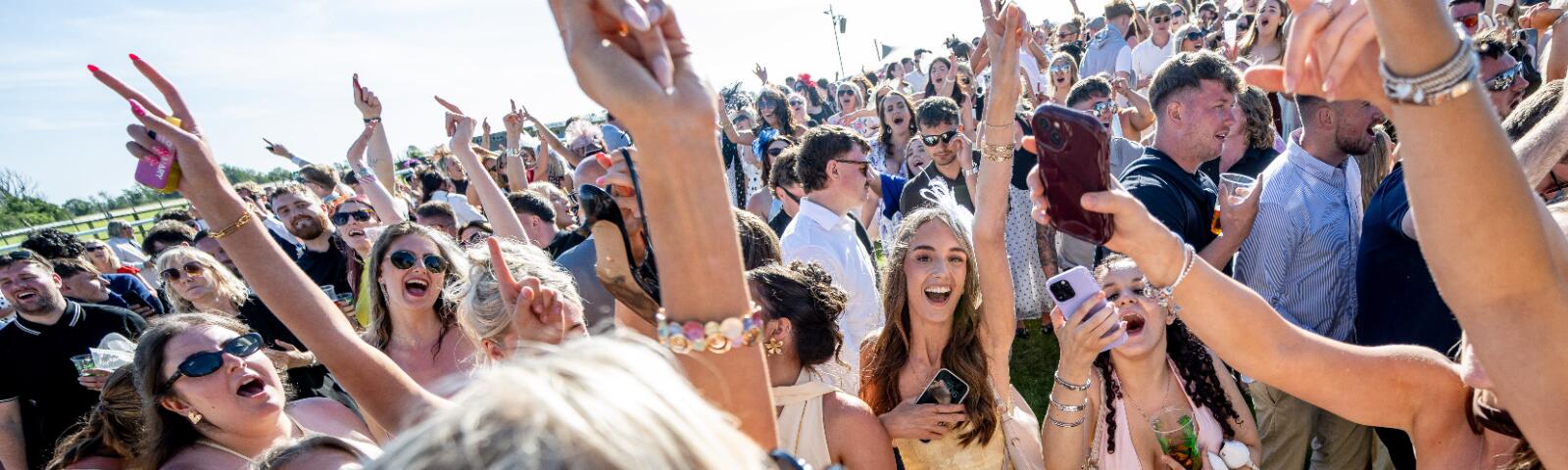 A young crowd at Bath Races enjoying the entertainment