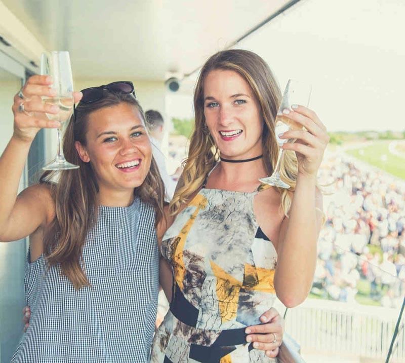 two women enjoying the races