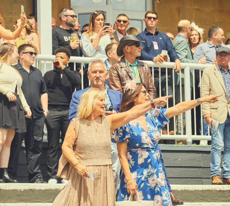 A group of race goers in the grandstand at Bath Races