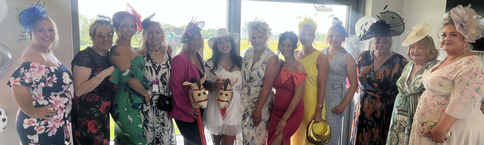 A bridal party pose in Bath Races hospitality for a hen do