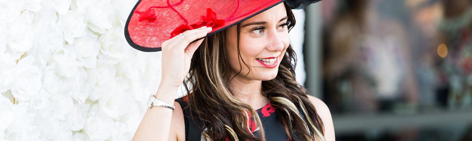 woman wearing red hat at ladies day