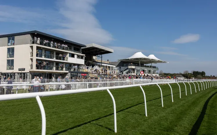 The track and packed grandstand at Bath Racecourse