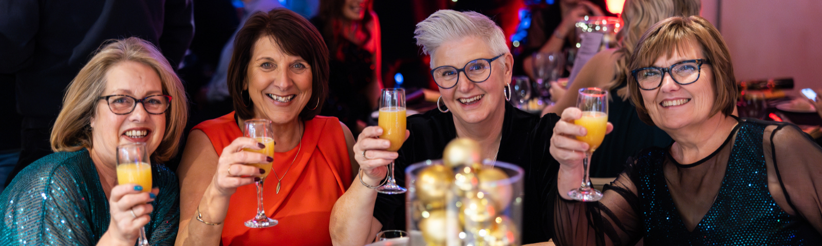 4 women cheersing glasses of champagne at a Christmas event held at Bath Racecourse