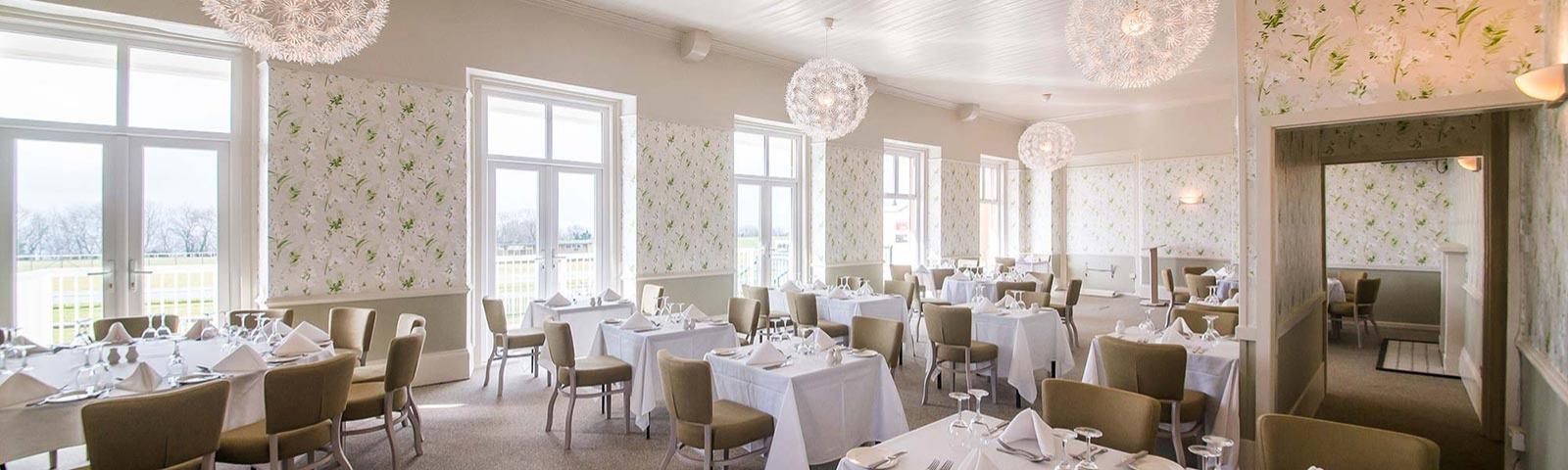 Interior view of the Mornington Suite with a number of tables set up for an event.