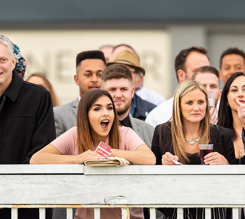 people watching the horse racing at bath racecourse