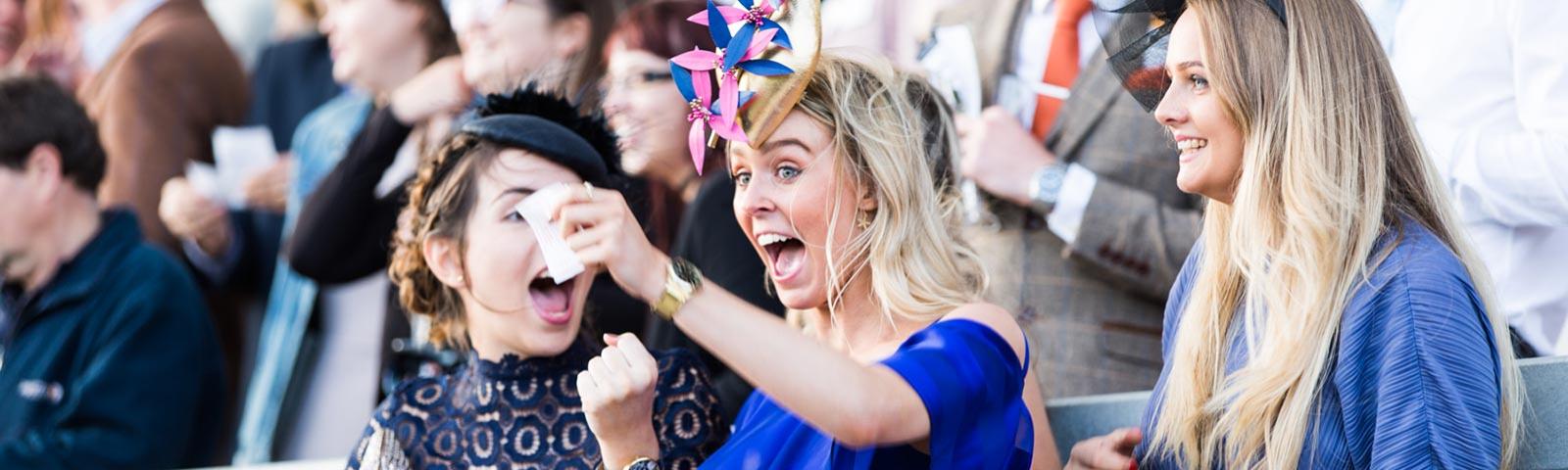 Two ladies cheering during a raceday at Bath Racecourse.