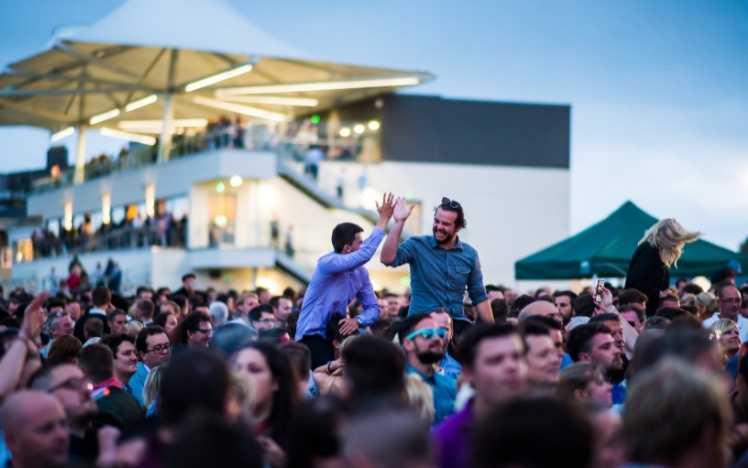 Two men high-five at a music night