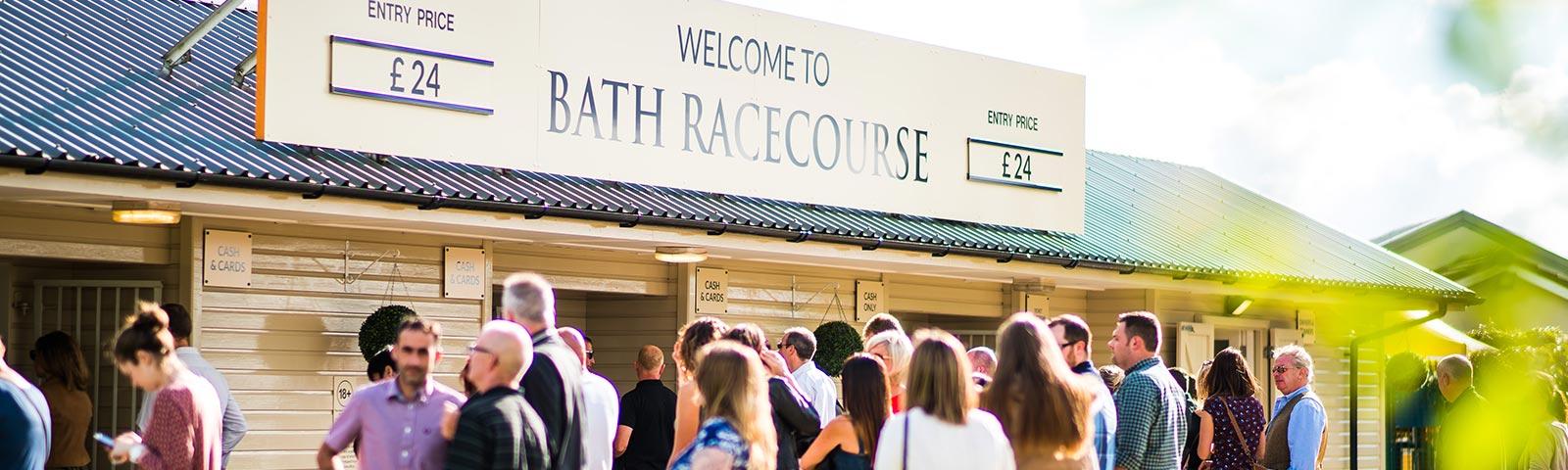 Main entrance to Bath Racecourse, with visitors lining up to get inside.
